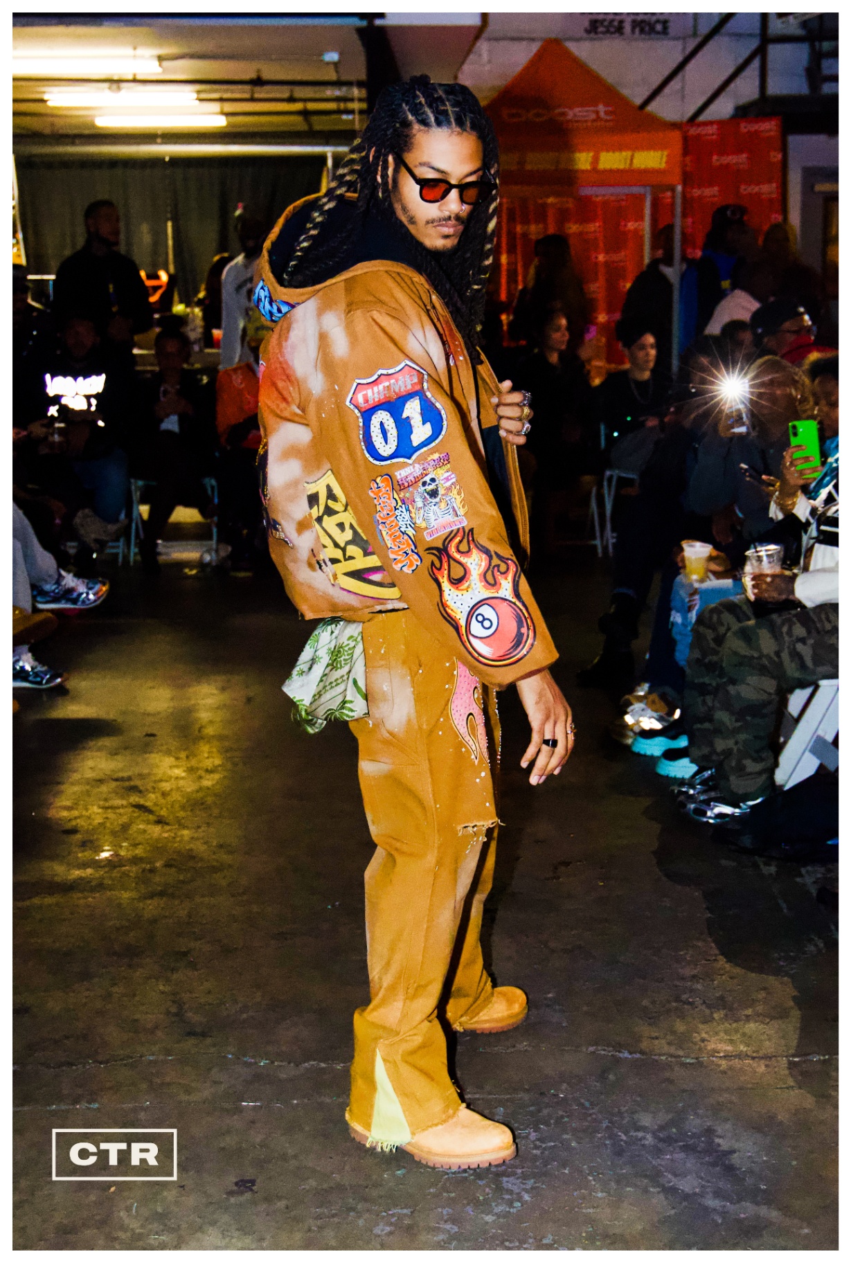 Runway — patchwork tan suit and red-tinted shades