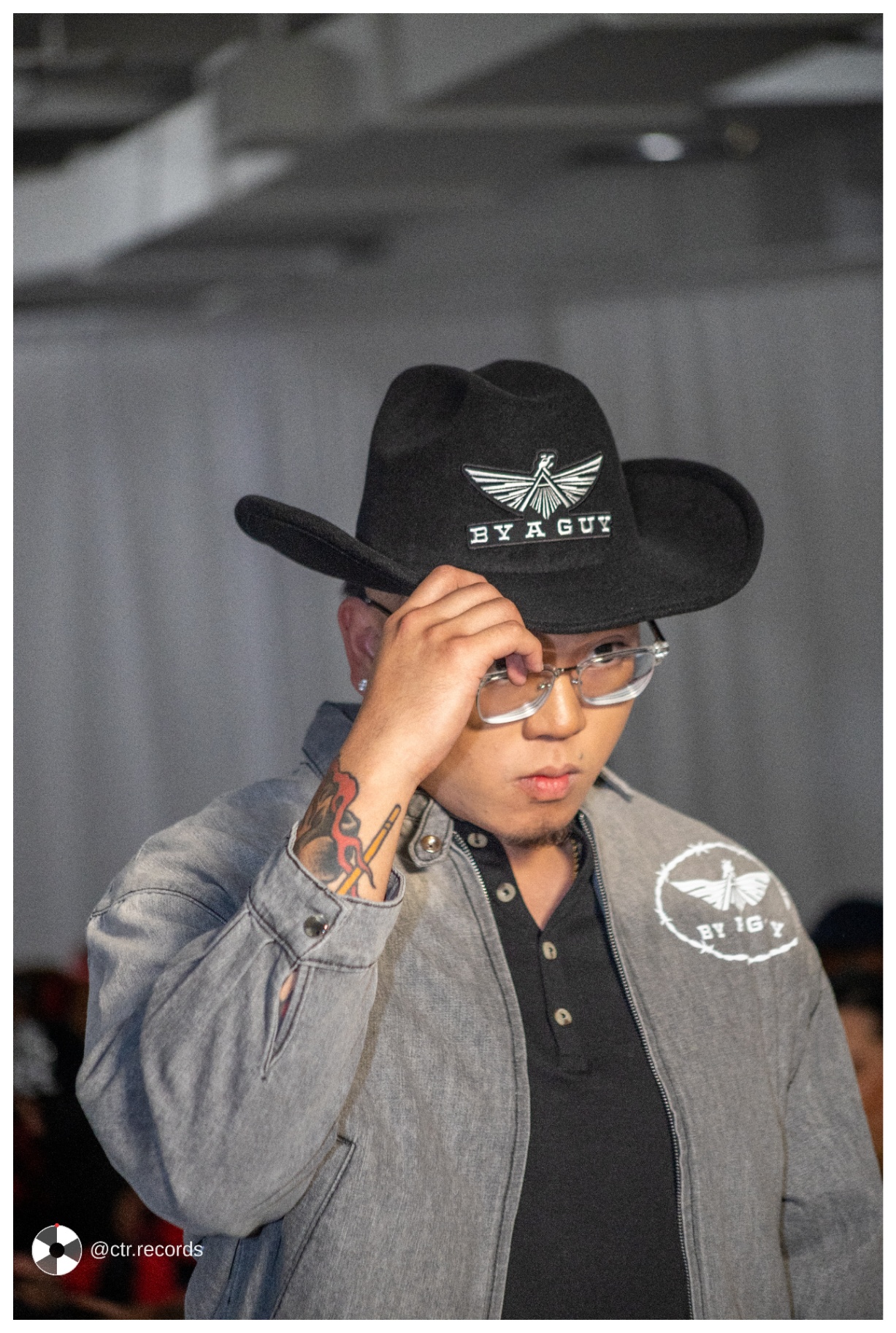 By A Guy — black cowboy hat, gray jacket