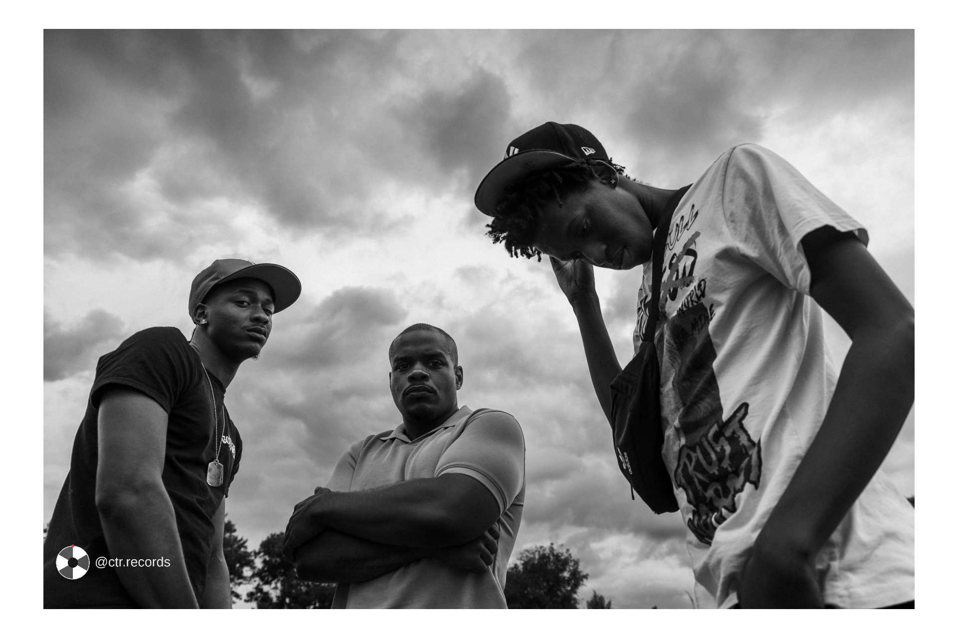 Three up — storm sky in black and white